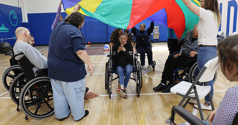 people playing with parachute in gymnasium