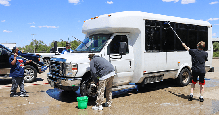 people washing a van