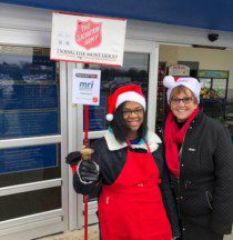 two people standing at Salvation Army stand